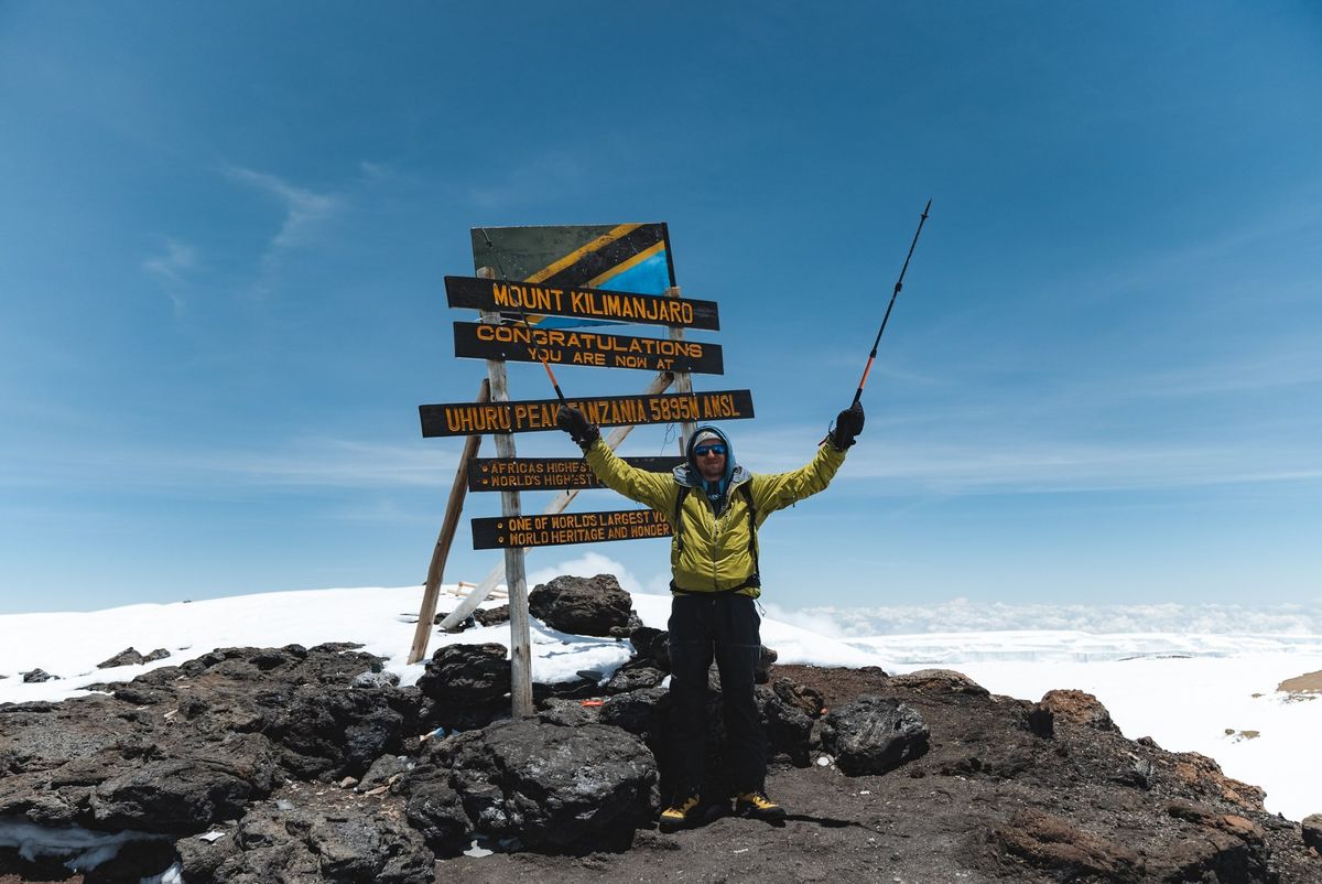 Celebrating at Uhuru Peak, the summit of Kilimanjaro